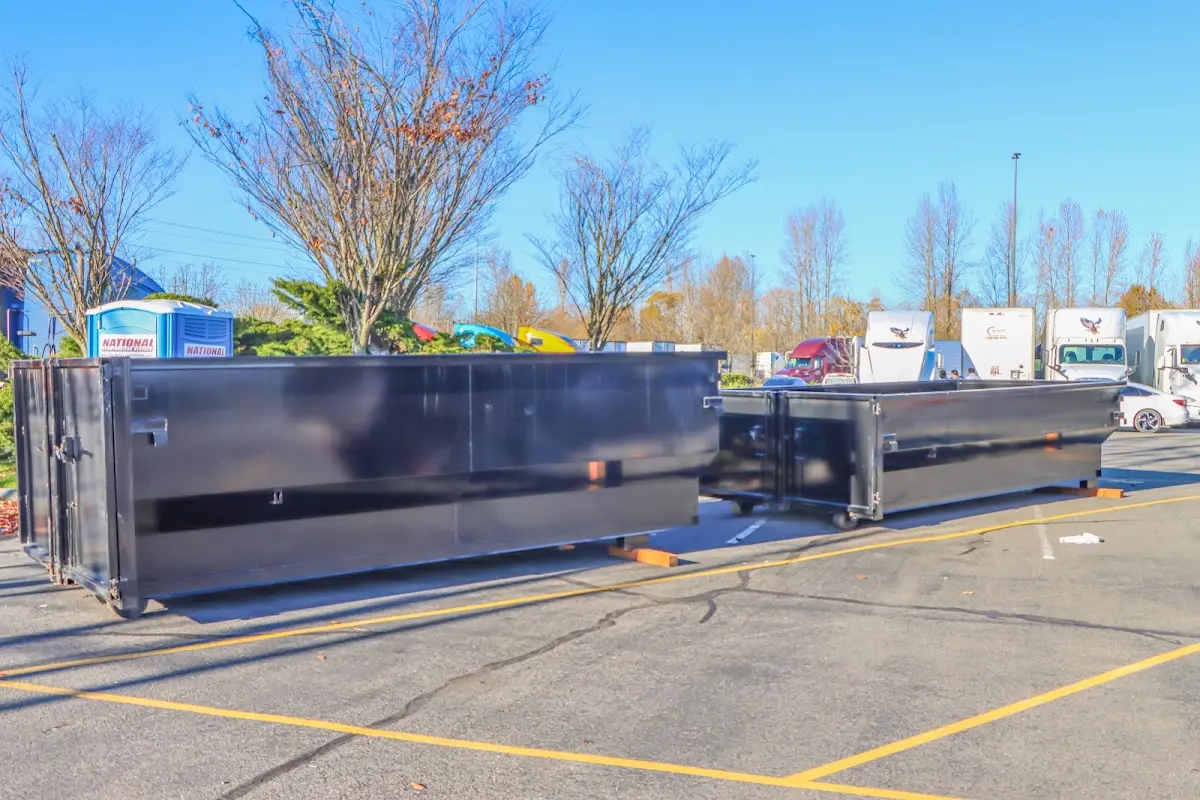 Professional dumpster rental service with roll-off container on residential driveway in West Caldwell